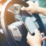 Driving while holding a mobile phone to work ,businessman ,vintage color tone