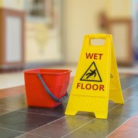 Warning yellow plastic sign of wet floor.